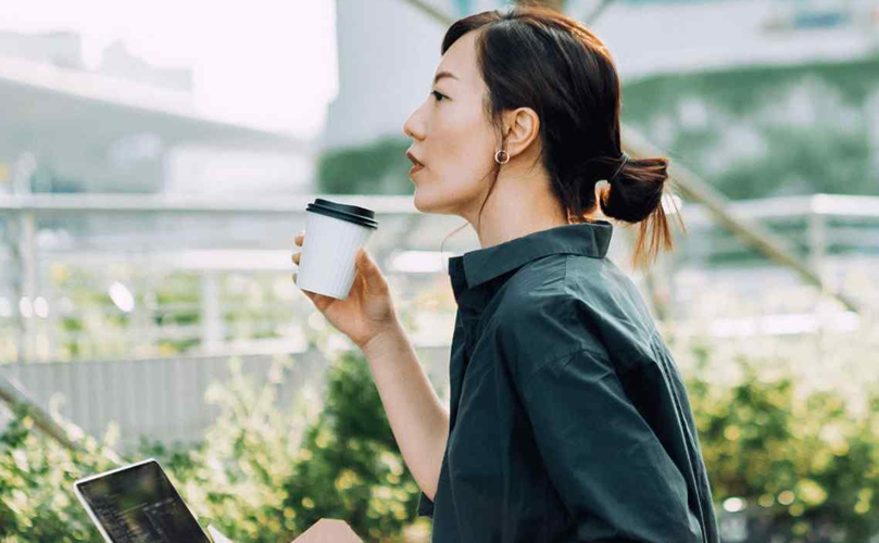 Worker drinking coffee outdoors