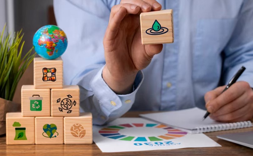 A man holds wooden blocks featuring various symbols, showcasing a playful and educational activity.