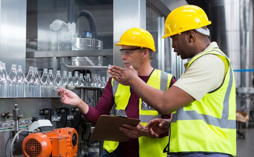 2 men working in a factory.