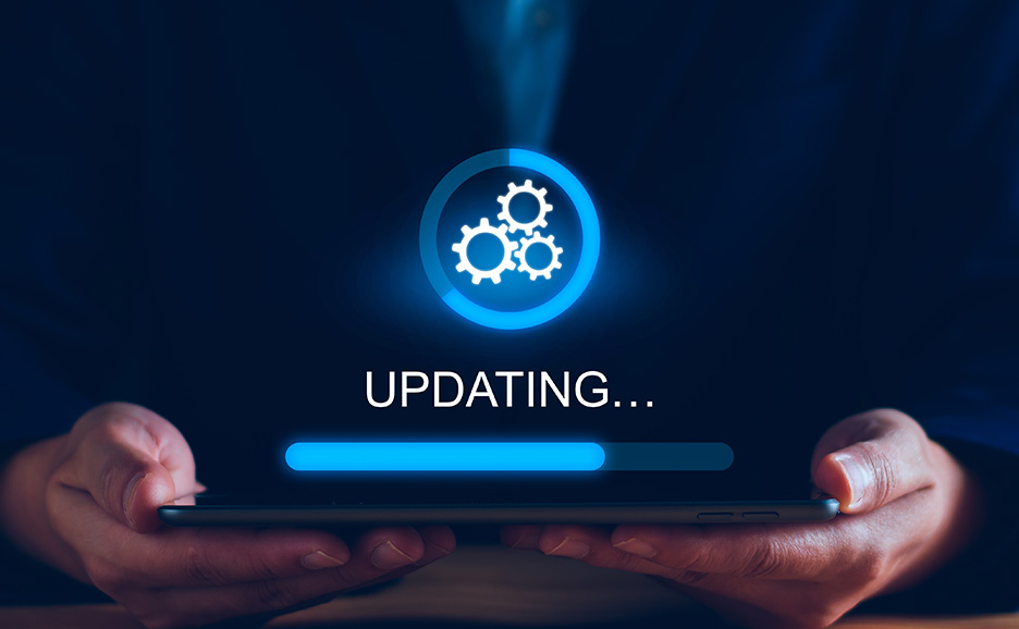 タブレットを手に、青い光で「UPDATING...」と表示されている。