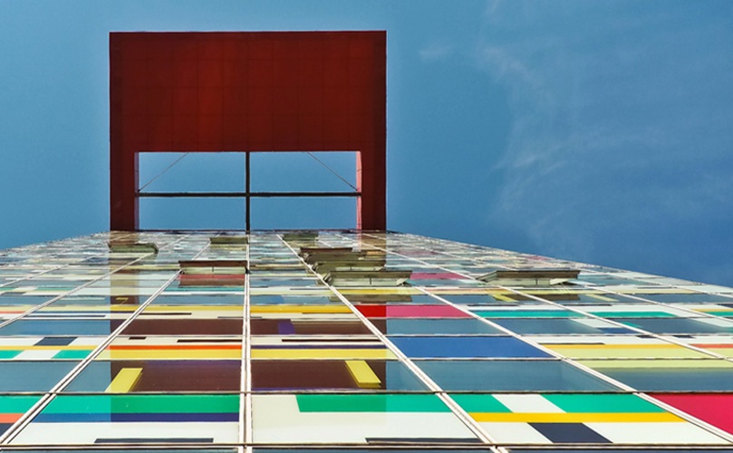 A colorful structure with a striking red door and bright windows, adding charm to the surrounding area.