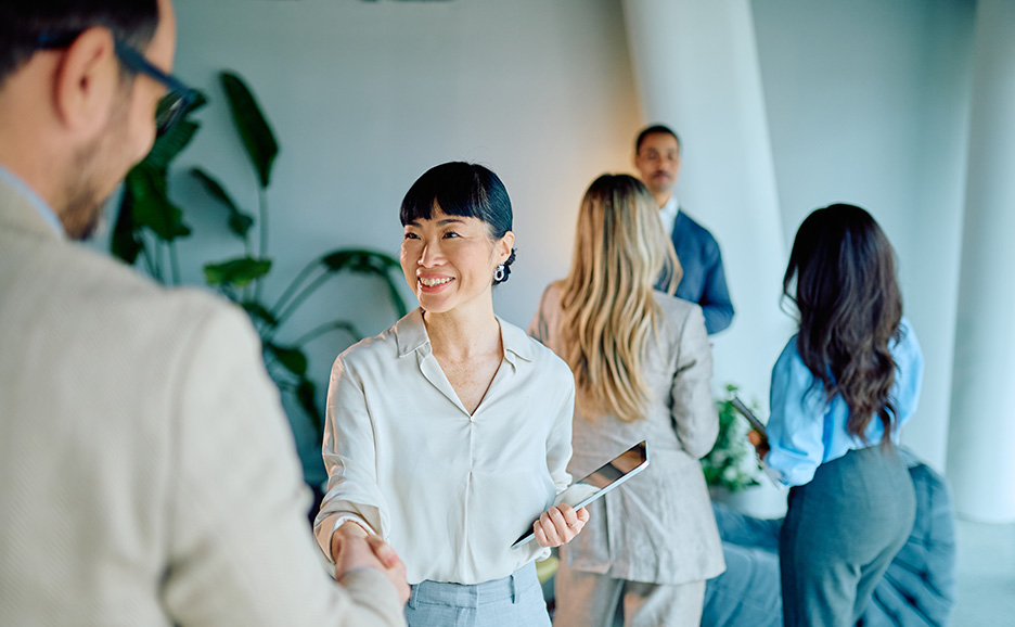 Man and woman shaking hands with smiles