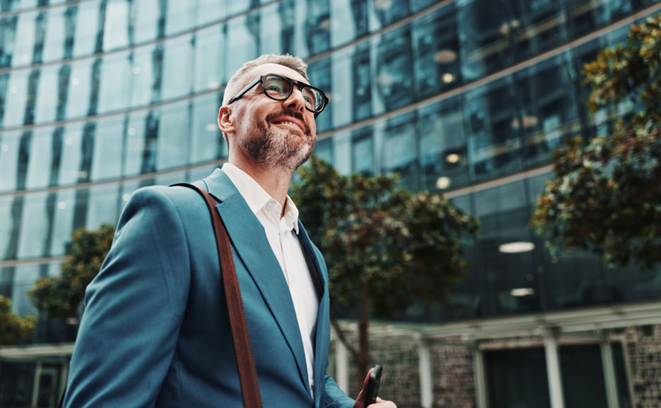 Man looking up while walking in a business district