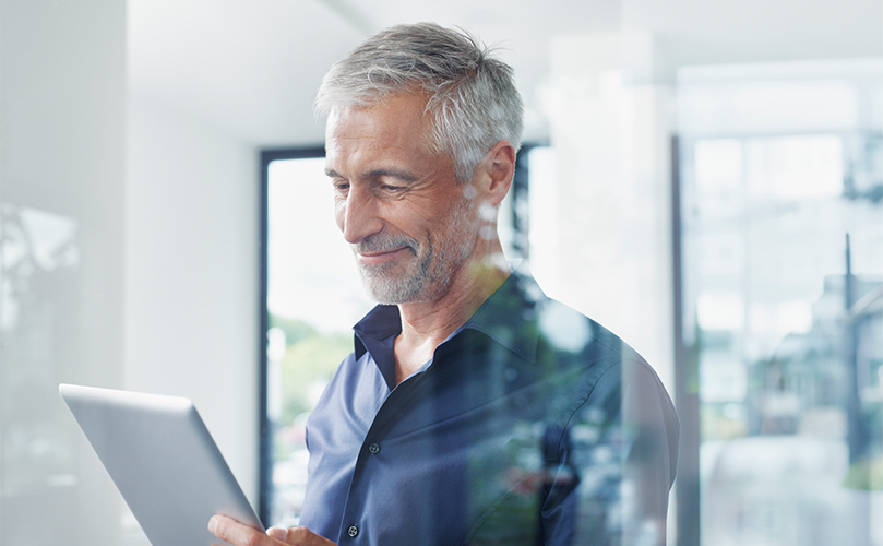 A man is observing a tablet computer