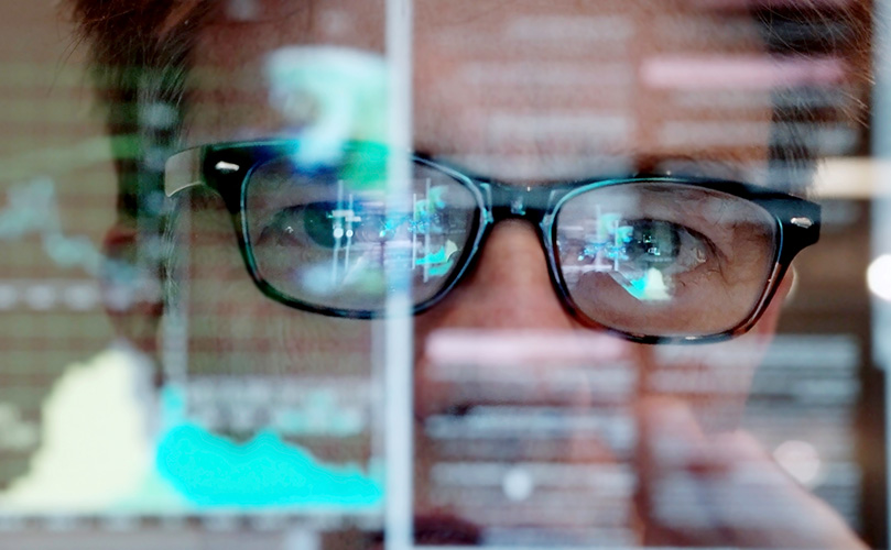 Picture of a man concentrating on a touchscreen display
