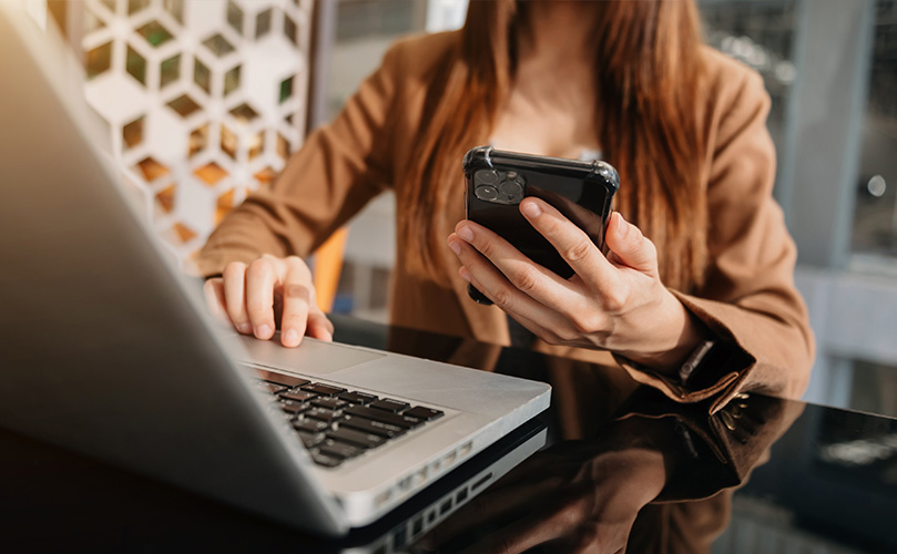 A woman using her smartphone for mobile payment online shopping.