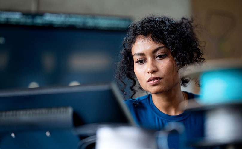 A female engineer who develops software on a PC