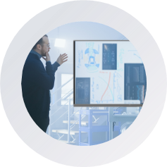 icon A man stands by a whiteboard displaying a diagram, engaged in a presentation or discussion.