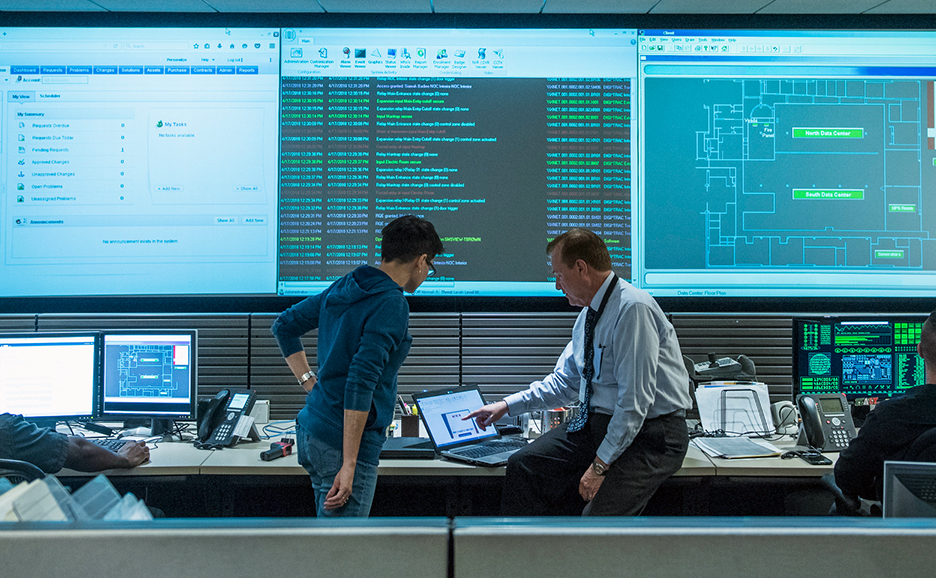 IT team monitoring and working with multiple screens
