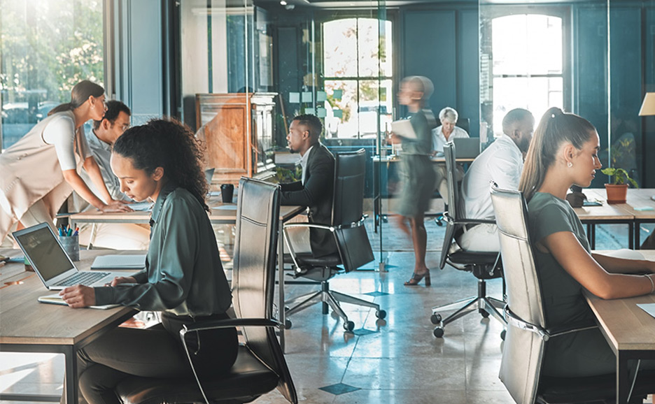A large number of businessmen working in an office.