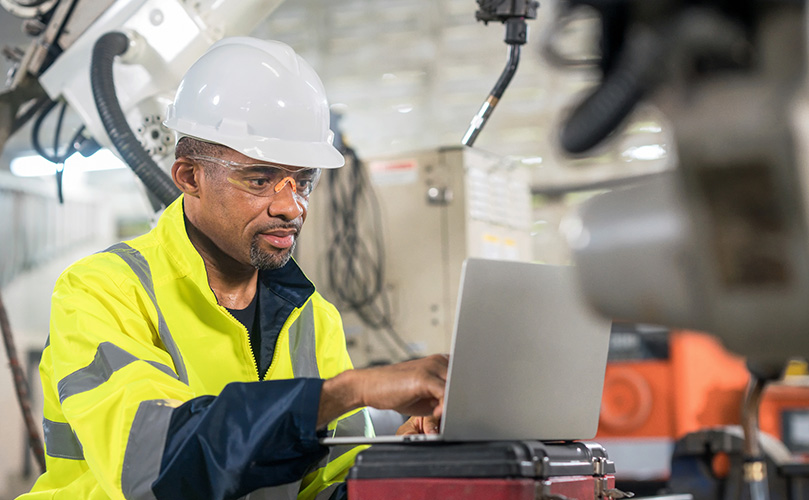 Manufacturing engineer looking at a computer