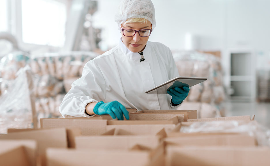 woman in sterile clothing checking materials