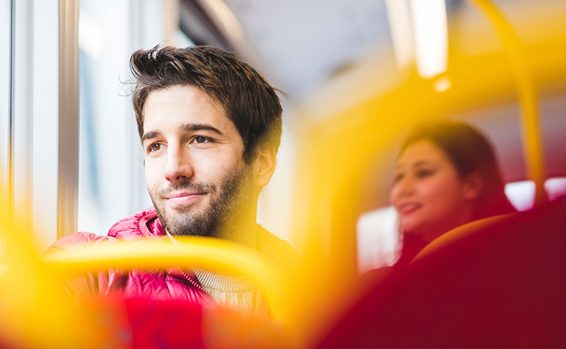A man on a bus looking out the window