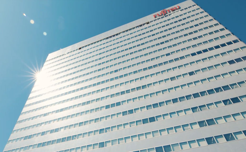 Fujitsu building against a bright blue sky.