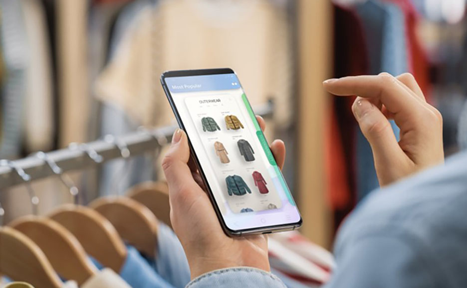 Person buying clothes with smartphone in a shop