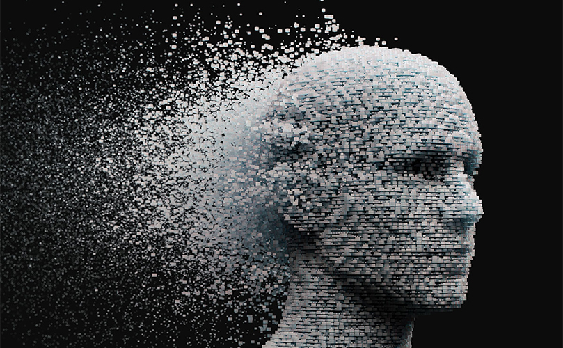 Digital head disintegrating into pixels on a black background with a gray square censoring a portion.
