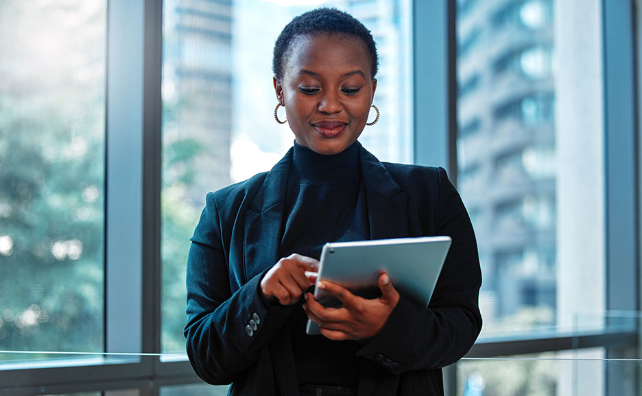 Young Black businesswoman using a digital tablet at work