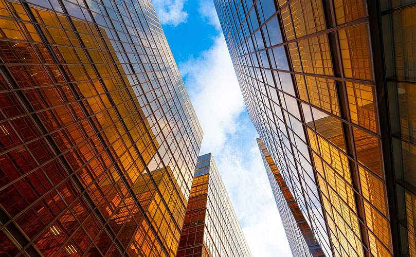 A view of a modern skyscraper in the business district from below