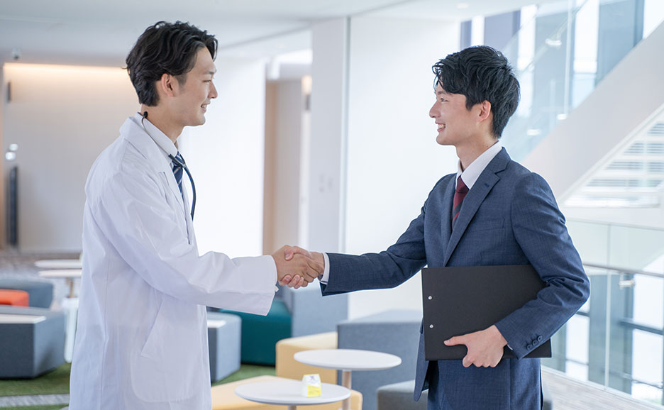 Doctor and sales rep shaking hands