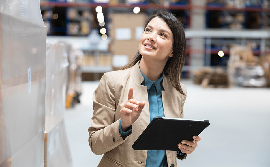 A woman checking a warehouse with a tablet