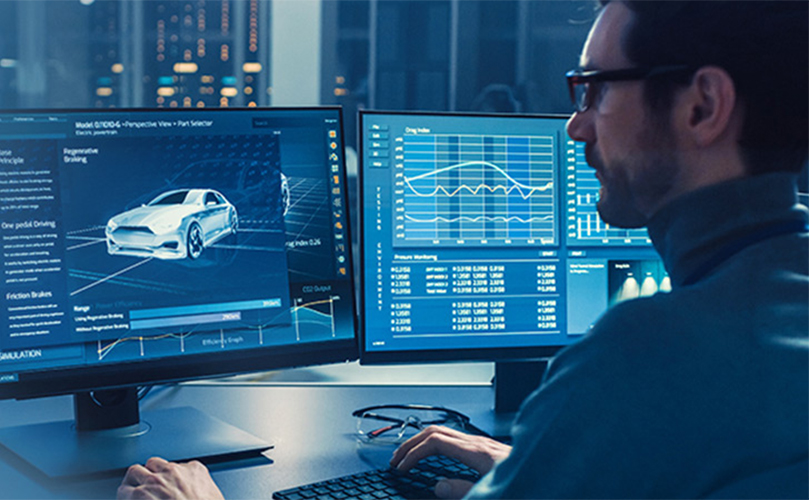 Man looking at a car design on a computer monitor