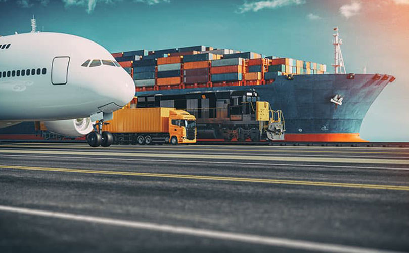 A large cargo ship, a truck and a plane next to each other