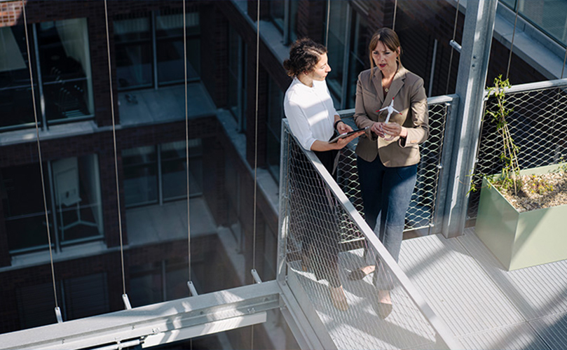 Image of a business woman talking on the stairs