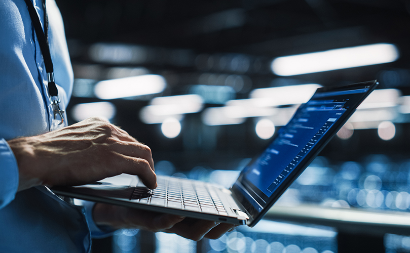 An image of a person typing on a laptop.
