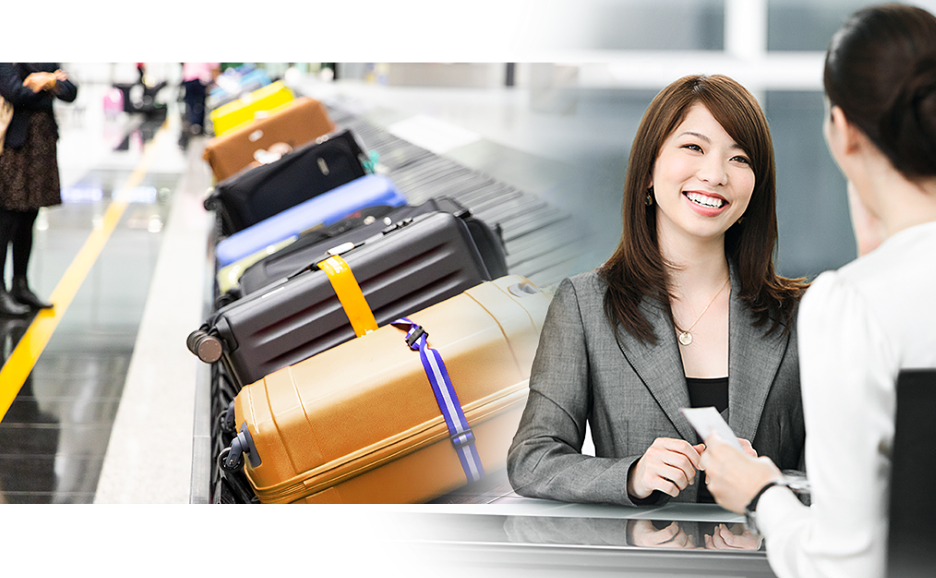A smiling cloakroom attendant with the baggage carousel in the background