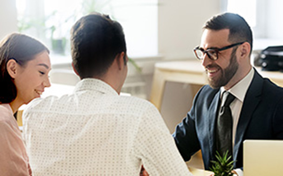 Bank teller assisting a young couple