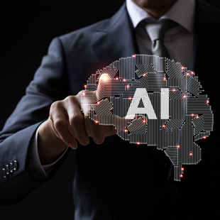 AIと書かれた脳のイメージグラフィックをタップするスーツ姿の男性