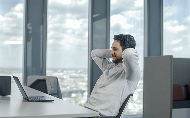 Person sitting at a desk with a laptop 
