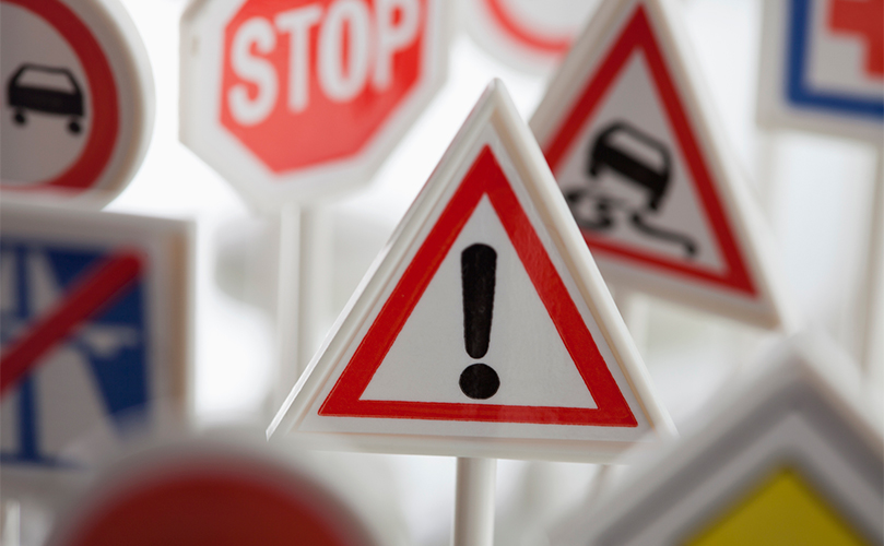a photograph of several different warning signs