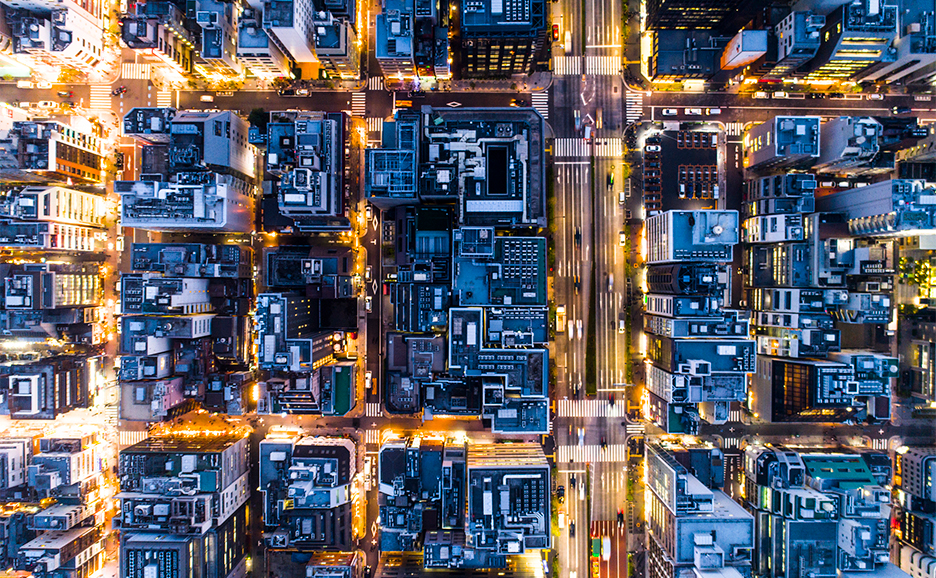 aerial view of a city with persony buildings and roads