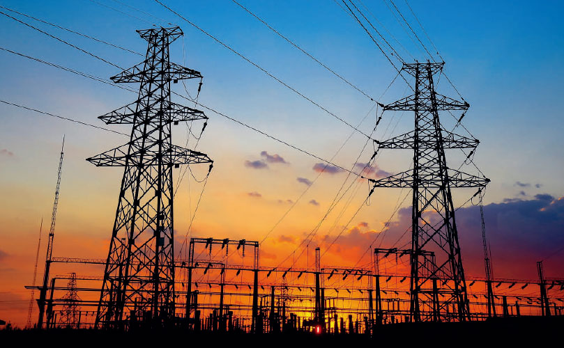 High voltage electrical towers at sunset