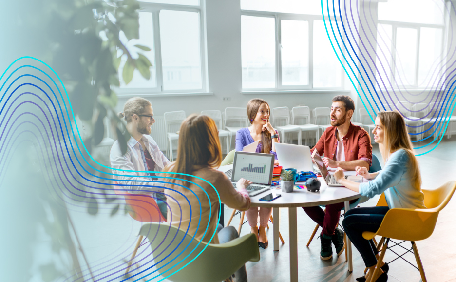 Photo of people happily discussing around a round table.
