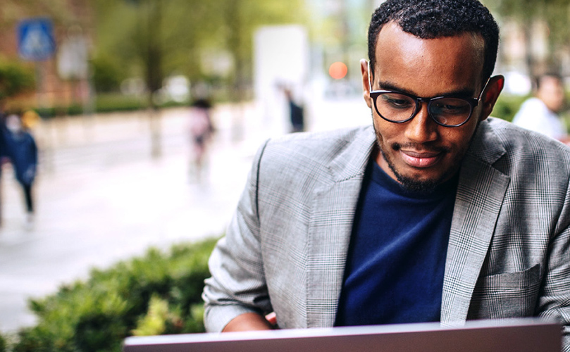 Businessman at park checking his laptop