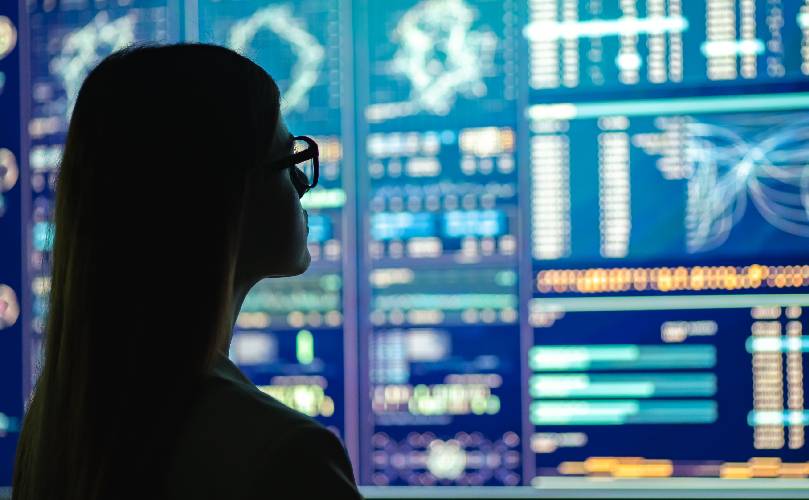 Woman looking and a display wall at night