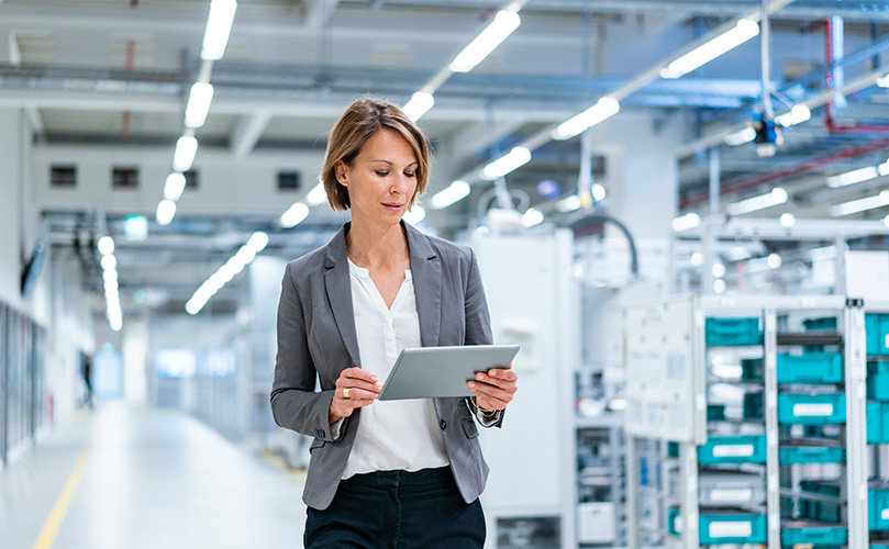 Businesswoman with tablet in a modern factory