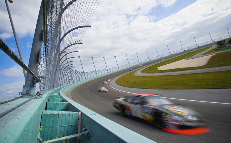 Stock cars racing around track