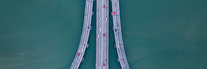 Aerial view of a bridge over water with cars.