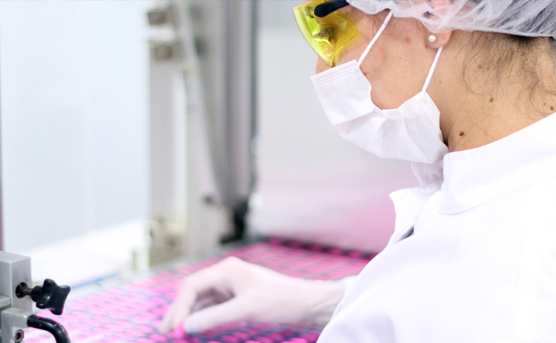 Scientist wearing a mask and protection glasses at a laboratory