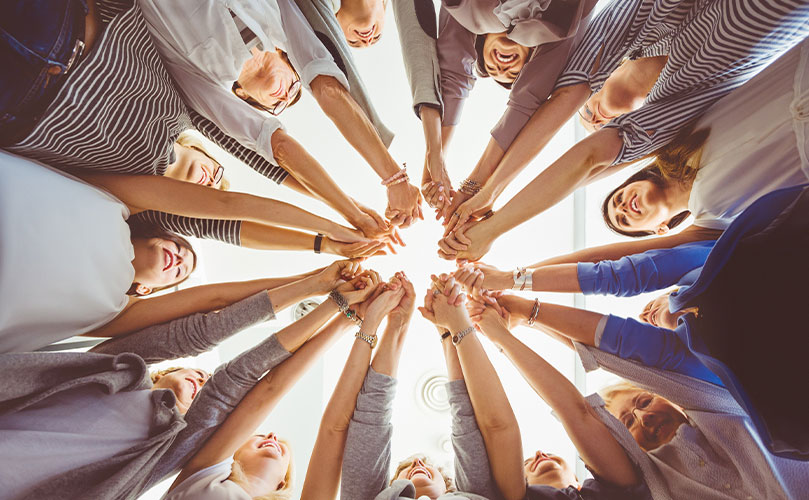 photo of a team holding hands